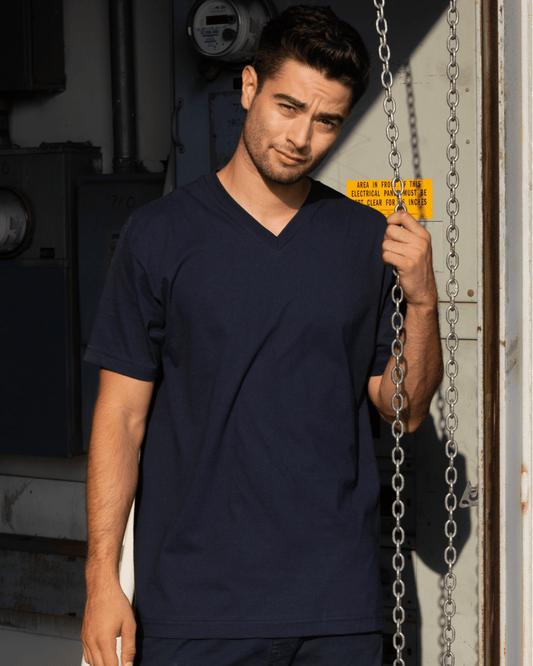 A man wearing a Navy Blue Suna Cotton® Adult V-neck T-shirt